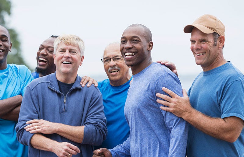 Smiling group of men of multiple ages and races