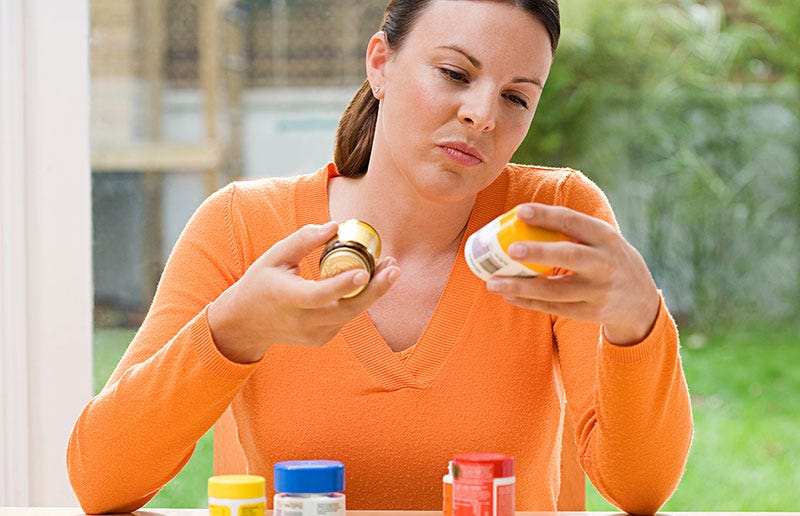 Women comparing different pill bottles